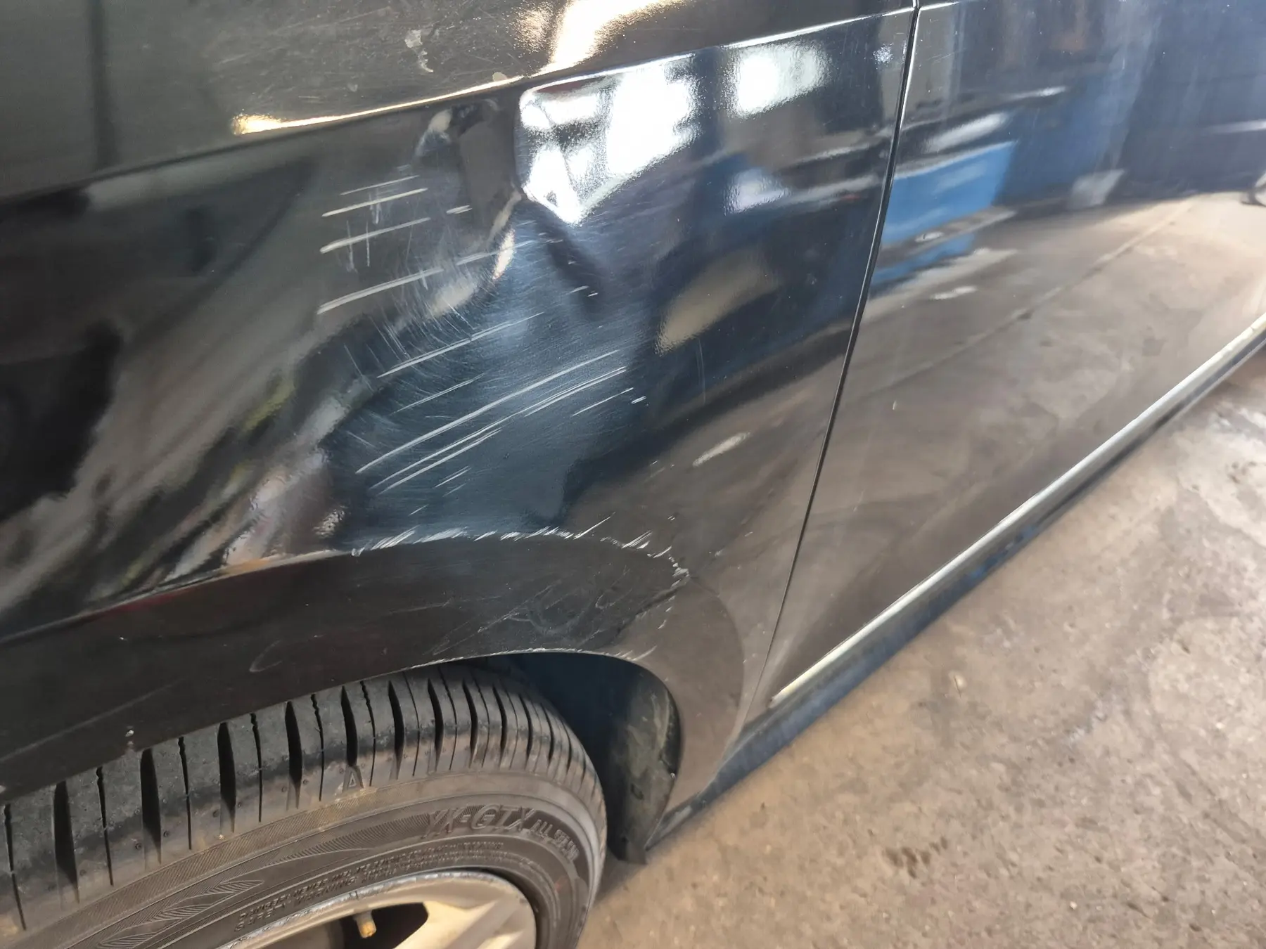 Damaged black side panel before polishing